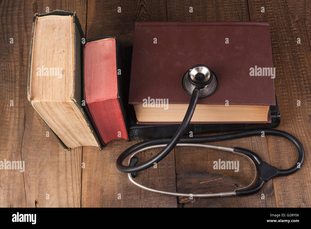 Old Books on Wood Table With Stethoscope Stock Photo - Alamy