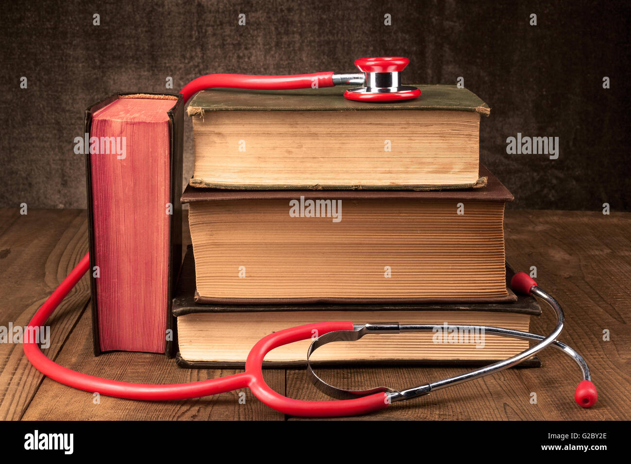 Old Books on Wood Table With Red Stethoscope Stock Photo - Alamy