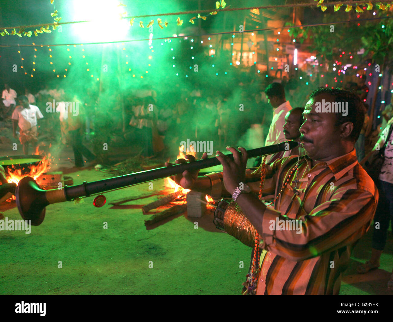 Musician playing a wind instrument, Nadhaswaram or Nagaswaram, at a
