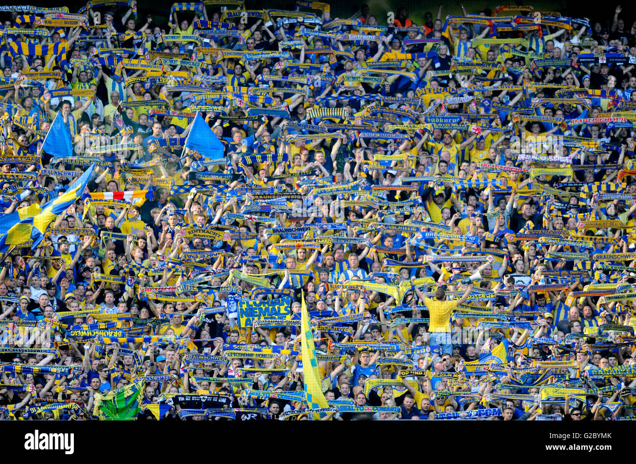 Fans of Ferencvarosi show their support as they hold scarves prior