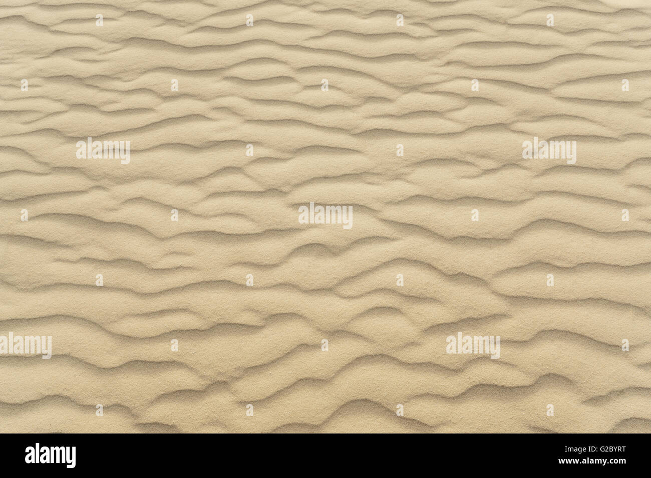 Waves of beach sand texture and background Stock Photo