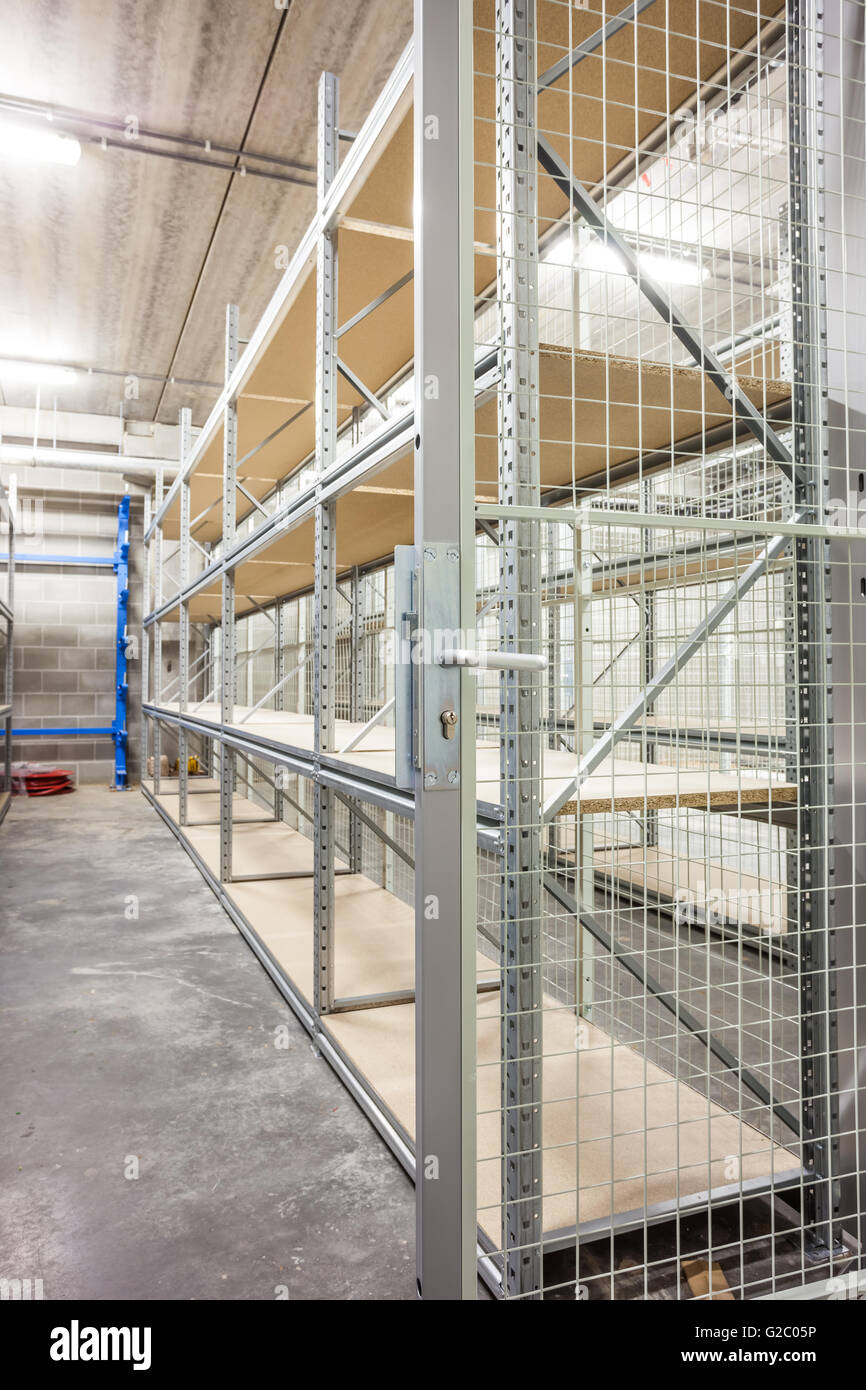 empty storage racks in a building with security Stock Photo - Alamy