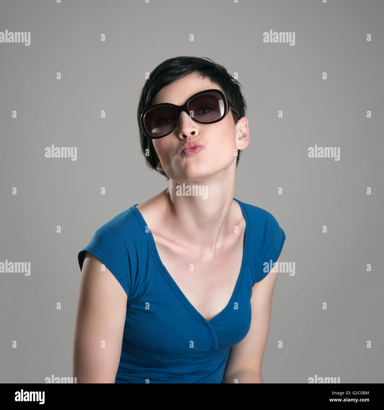 Cute Charming Short Hair Woman Wearing Sunglasses Blowing Air Kiss