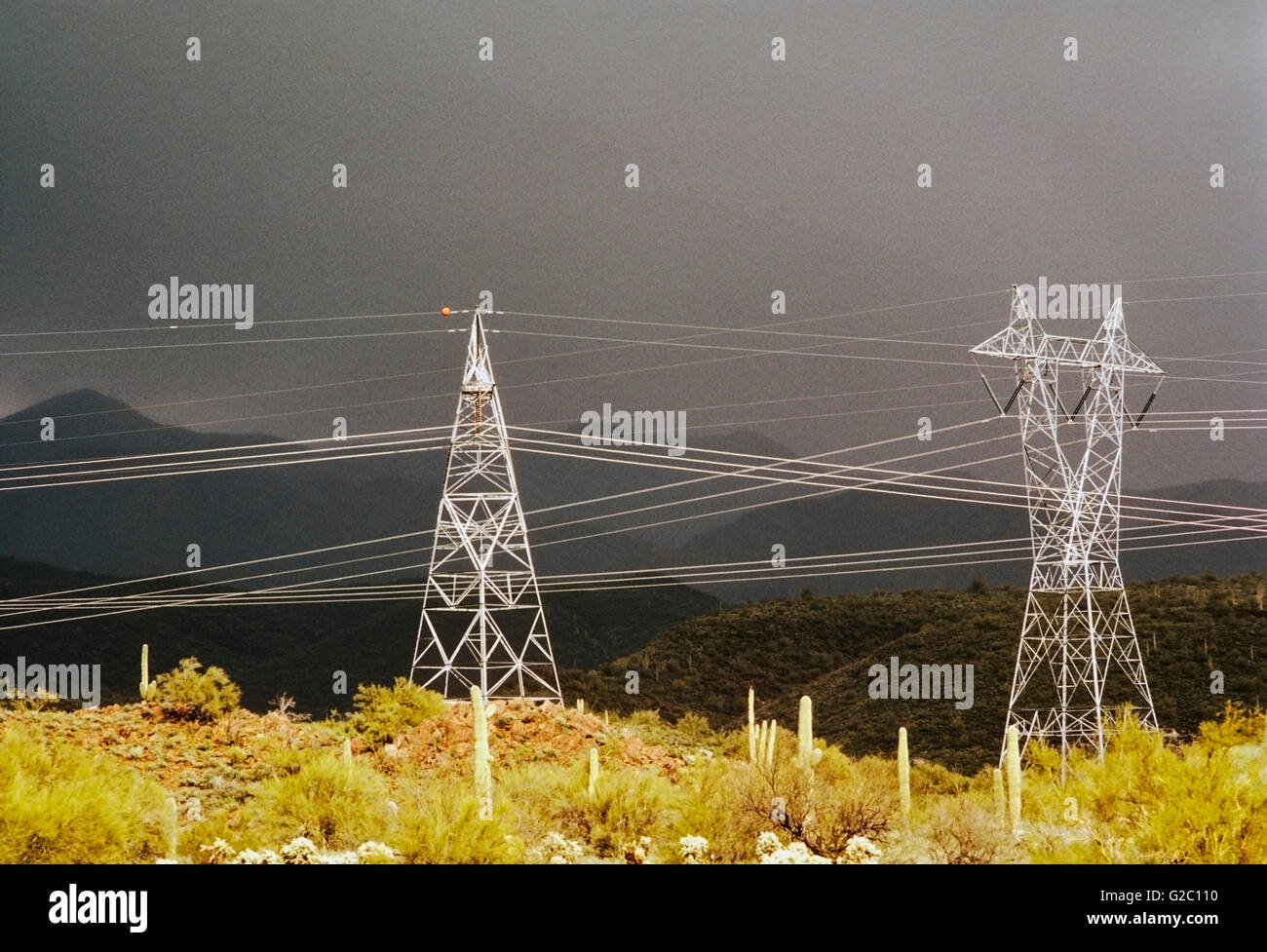Electrical transmission lines and towers with a dramatic storm sky in the desert north of