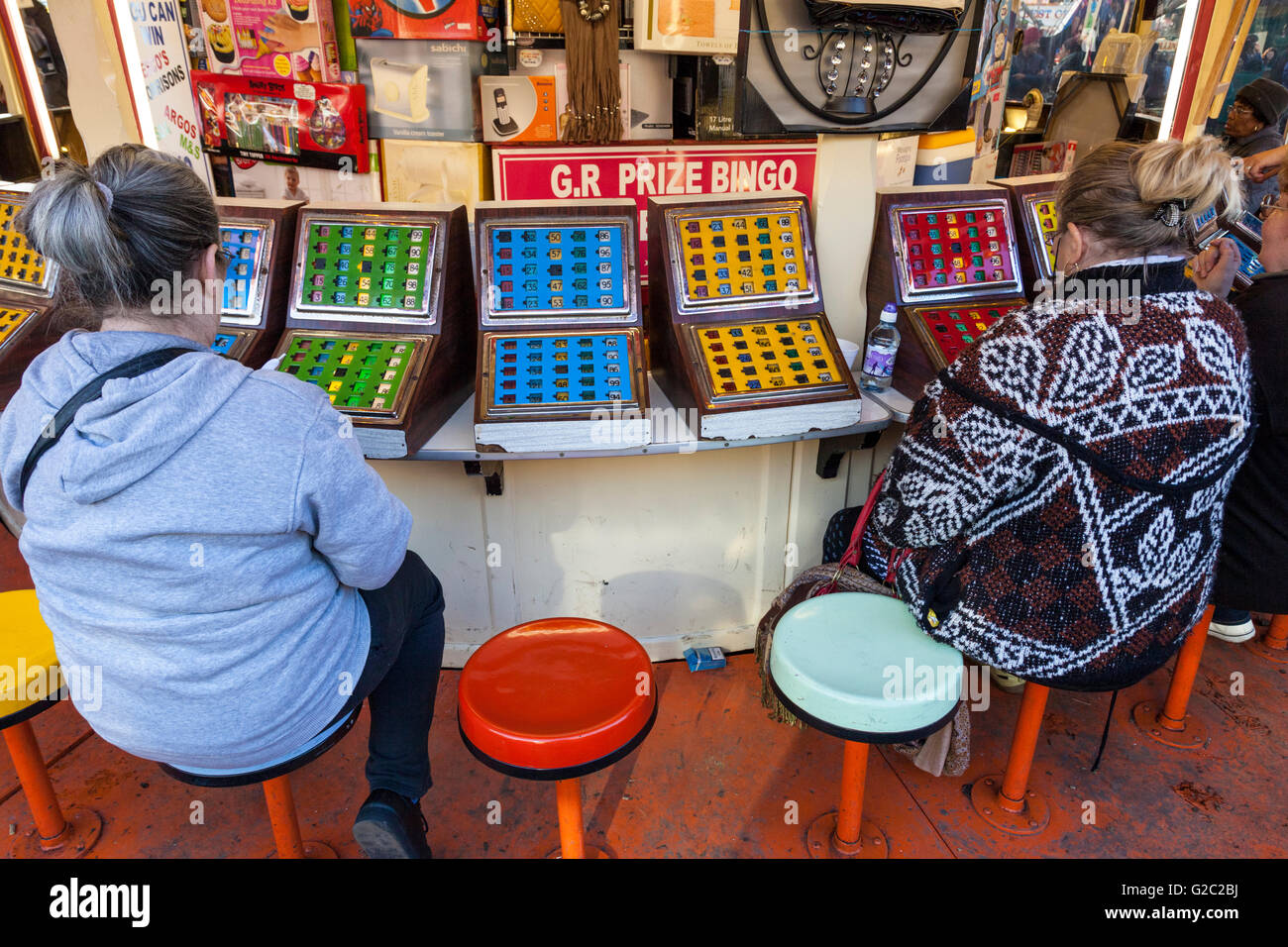 Fairground amusements. Women sat playing bingo at Goose Fair, Nottingham, England, UK Stock Photo