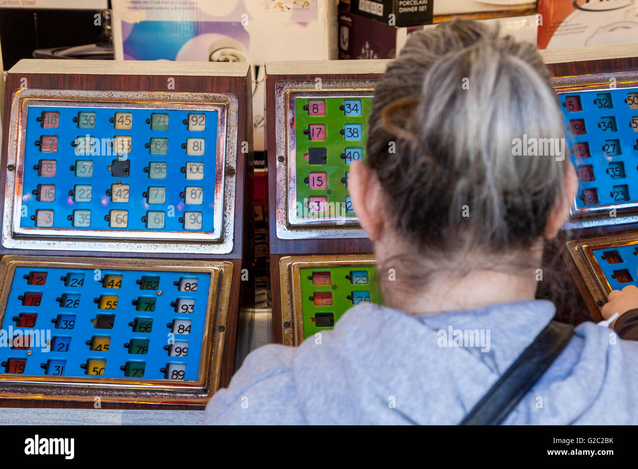 Fairground amusements. Woman playing a bingo machine at Goose Fair, Nottingham, England, UK Stock Photo