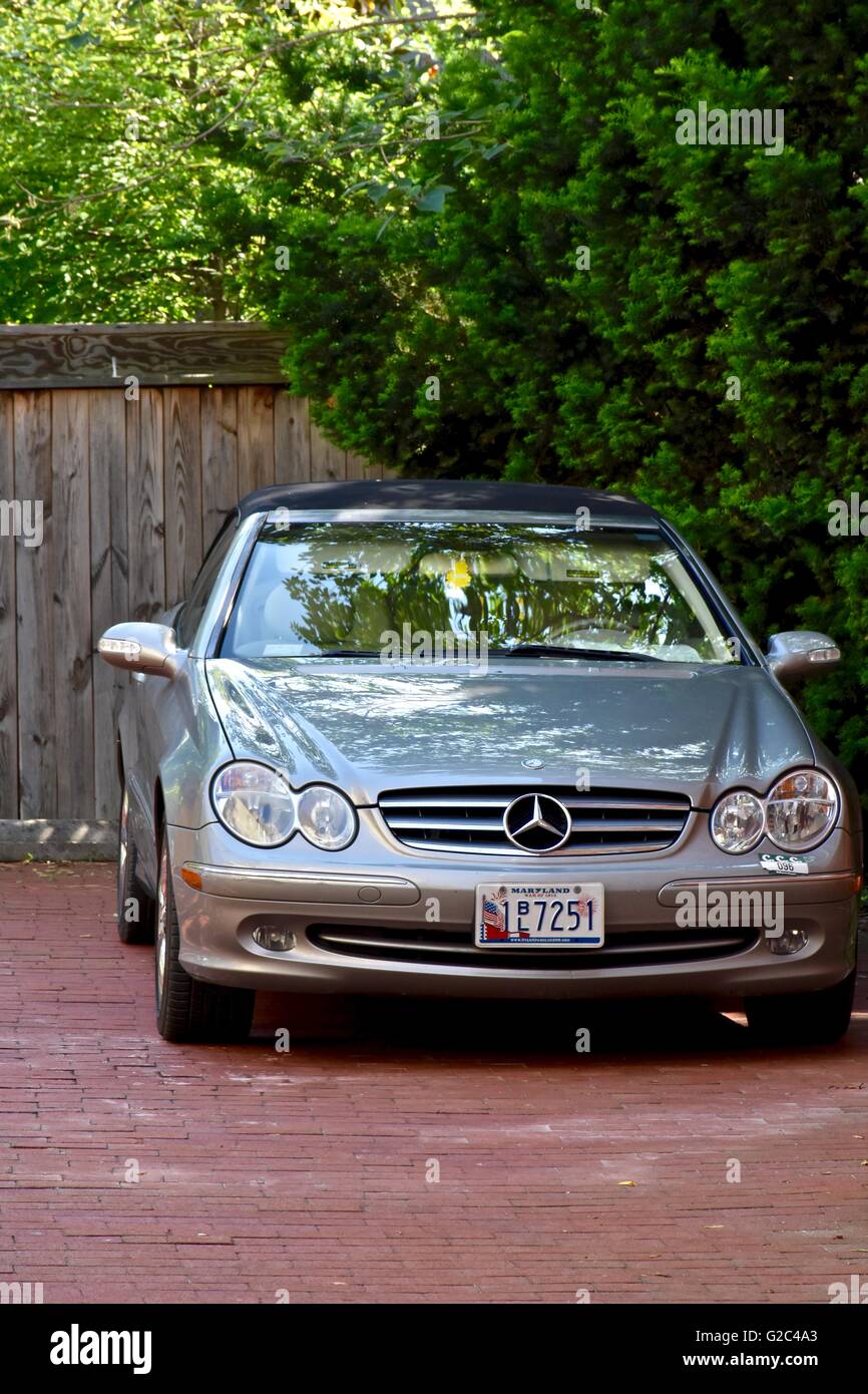 A MercedesBenz parked outside a residential home in the drive way