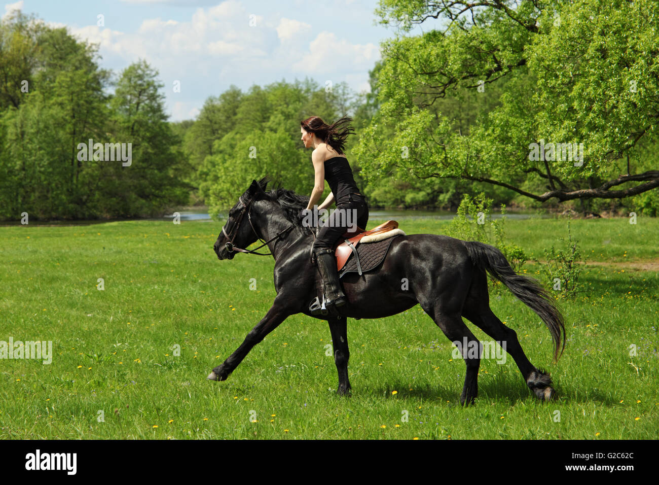 Cheerful cowgirl and her galloping horse Stock Photo