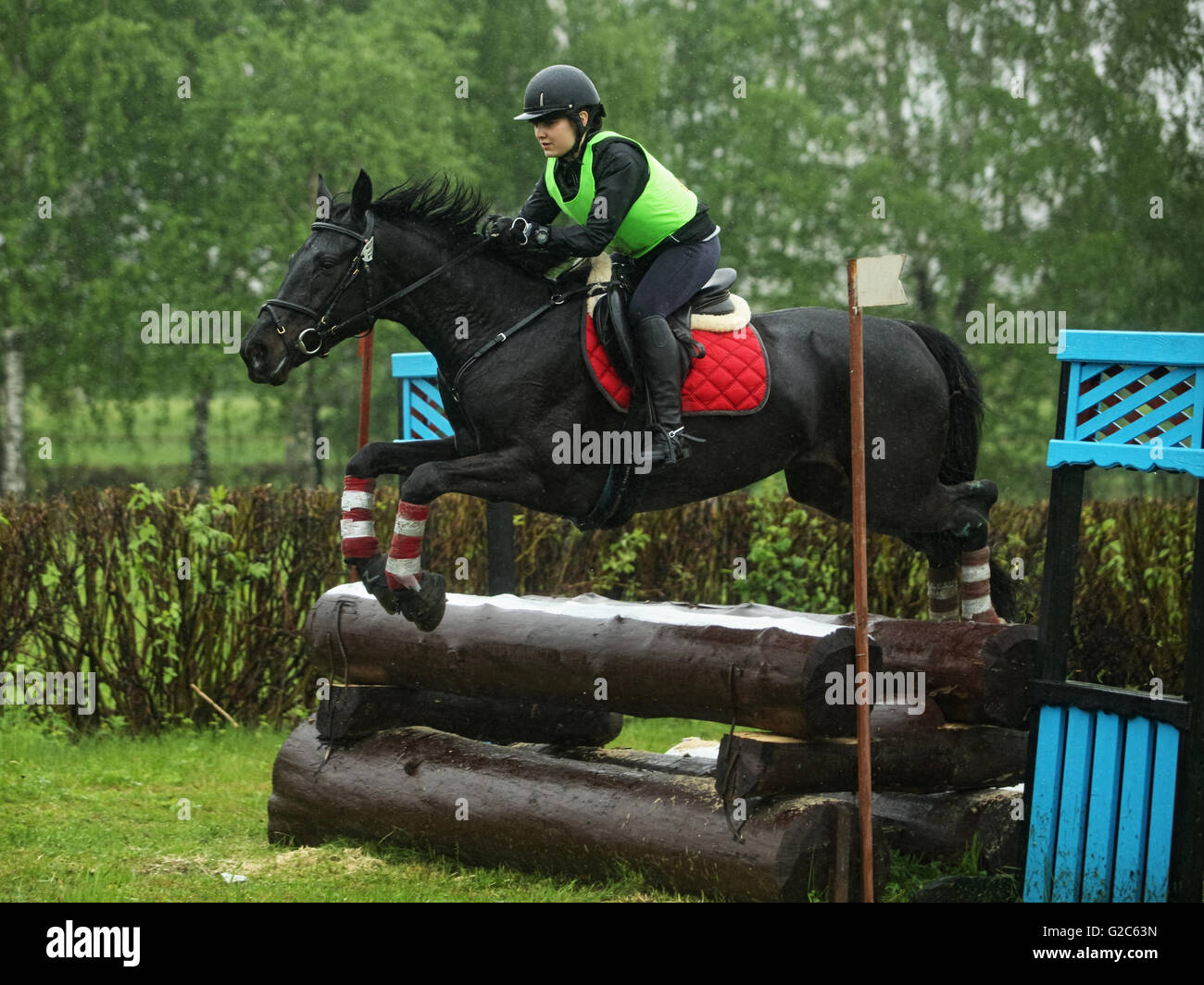 Horse rider jumps a water during a three day eventing Stock Photo