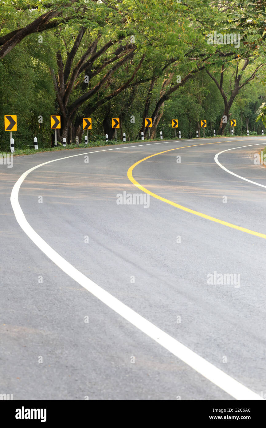 The road curve with street signs reflex light,At night you can see the signs more clearly. Stock Photo