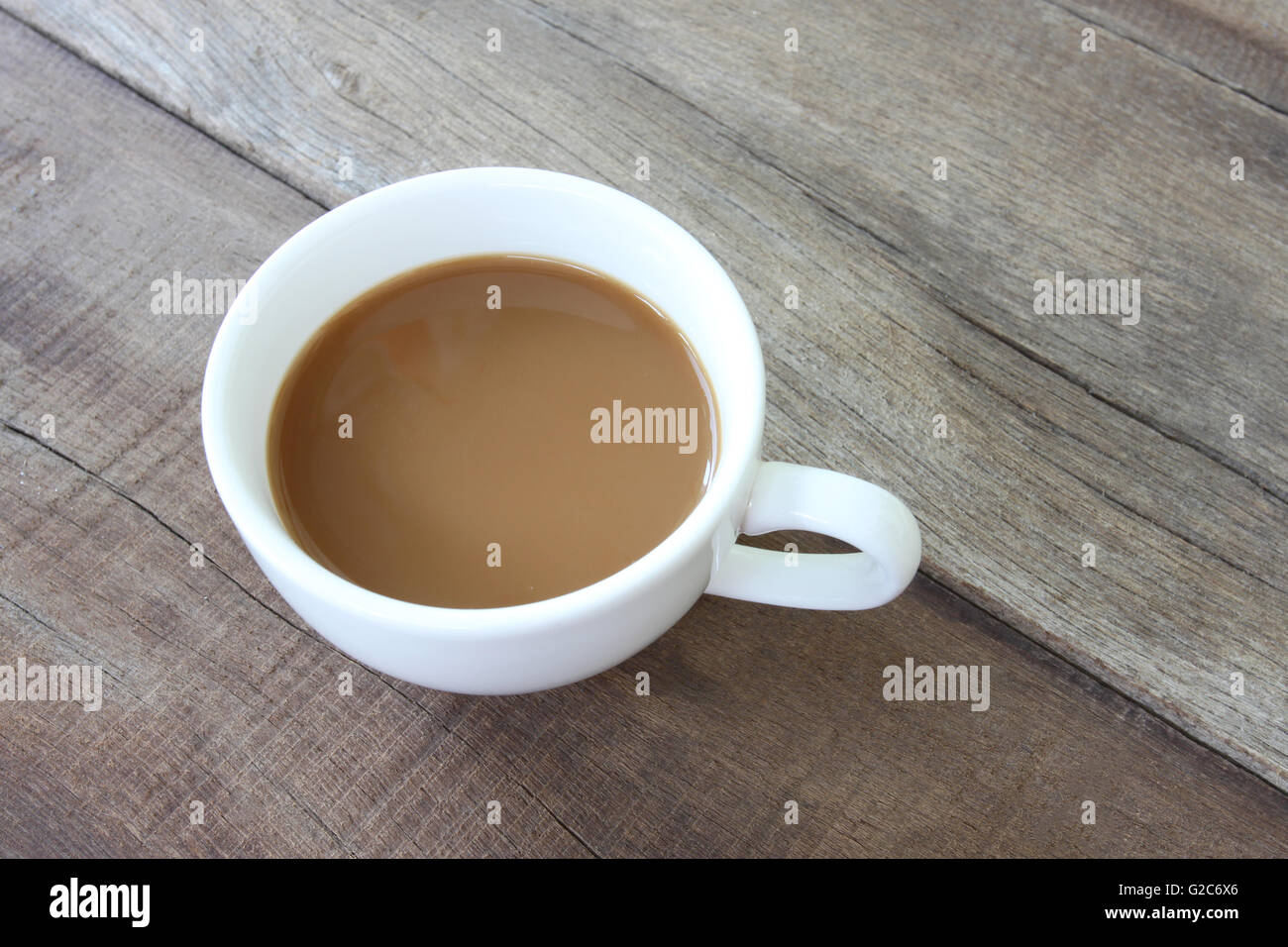 White coffee cup on a wooden floor and concept for beverage. Stock Photo