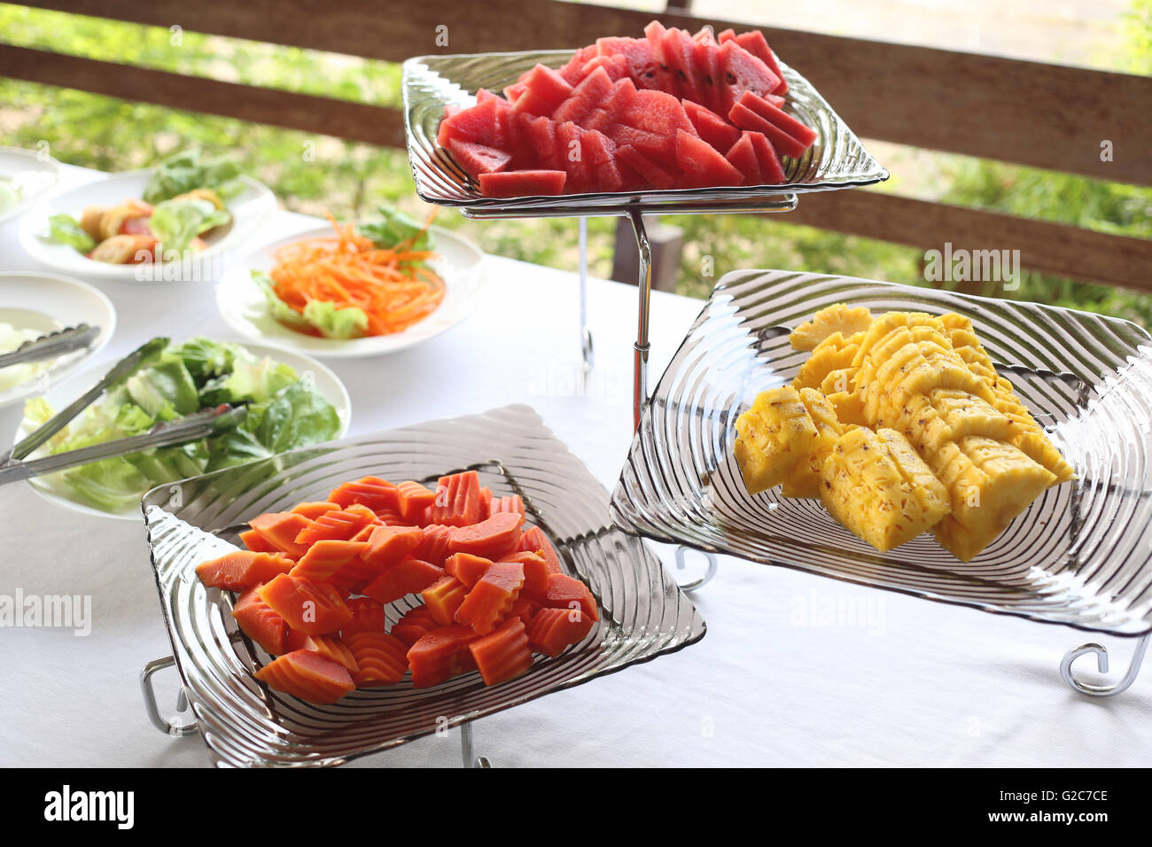 Sliced watermelon Pineapple and ripe papaya of mix fruit in a dish on food table. Stock Photo