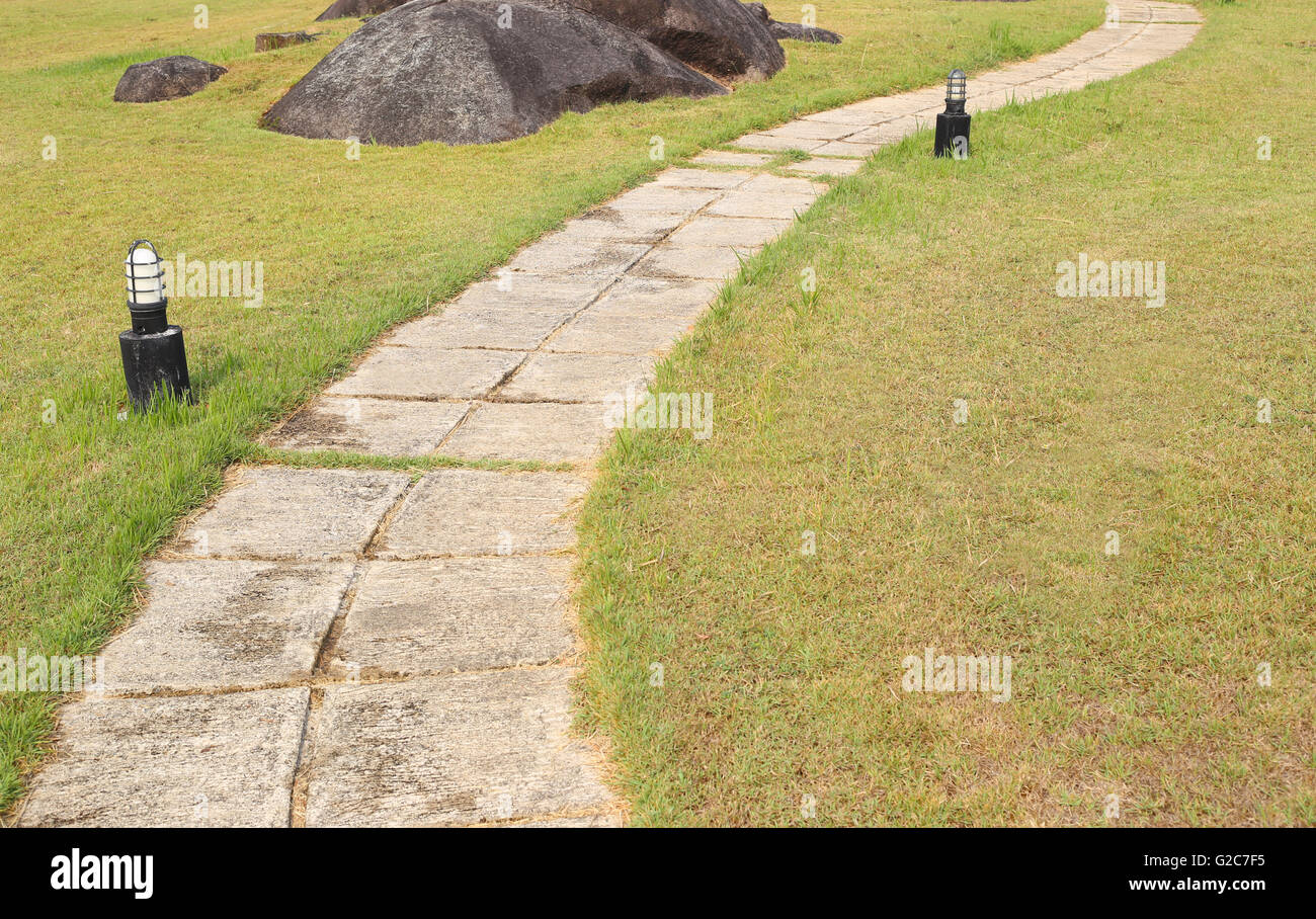 Green lawn and concrete walkway in design and decoration outdoor. Stock Photo