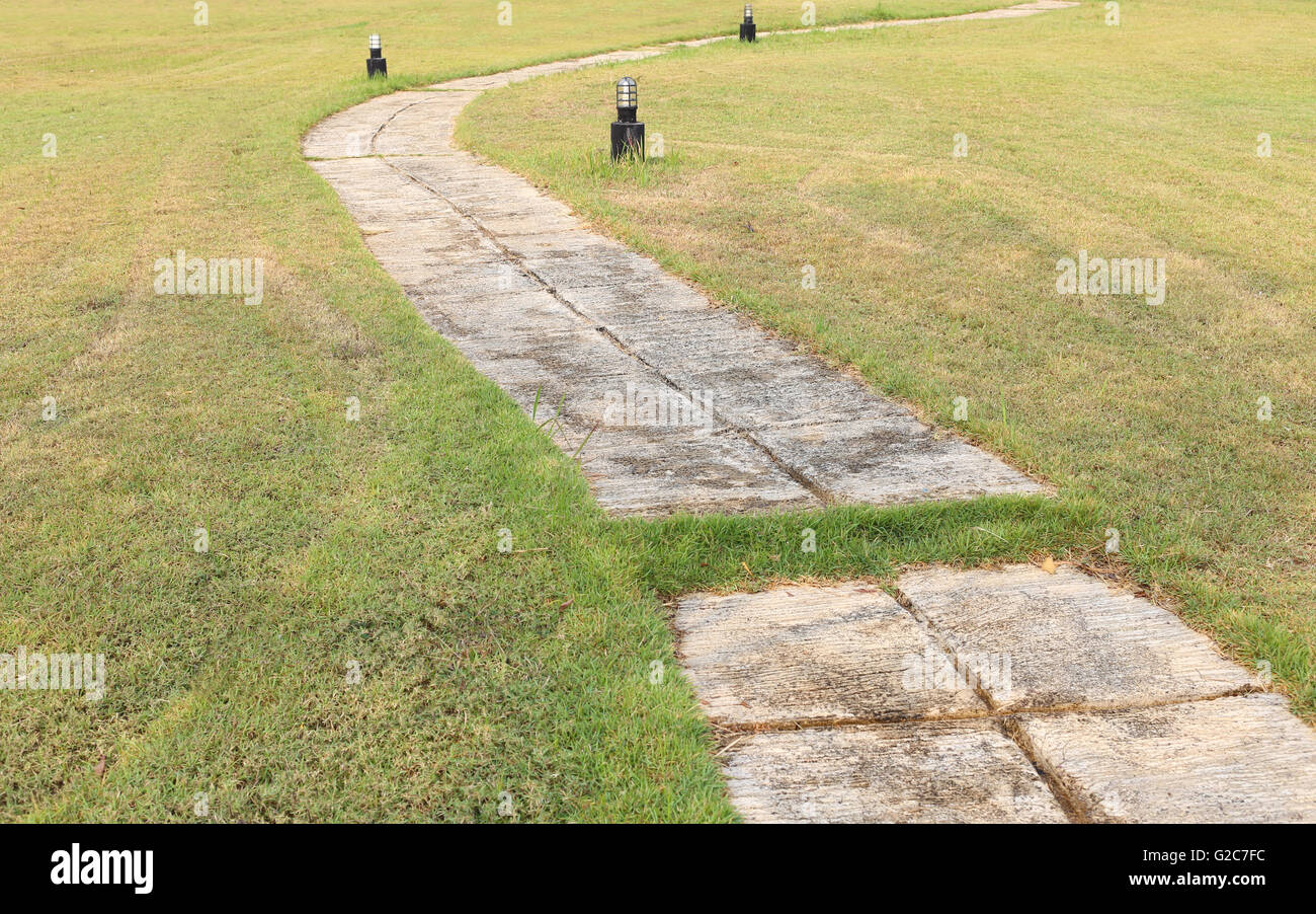 Green lawn and concrete walkway in design and decoration outdoor. Stock Photo