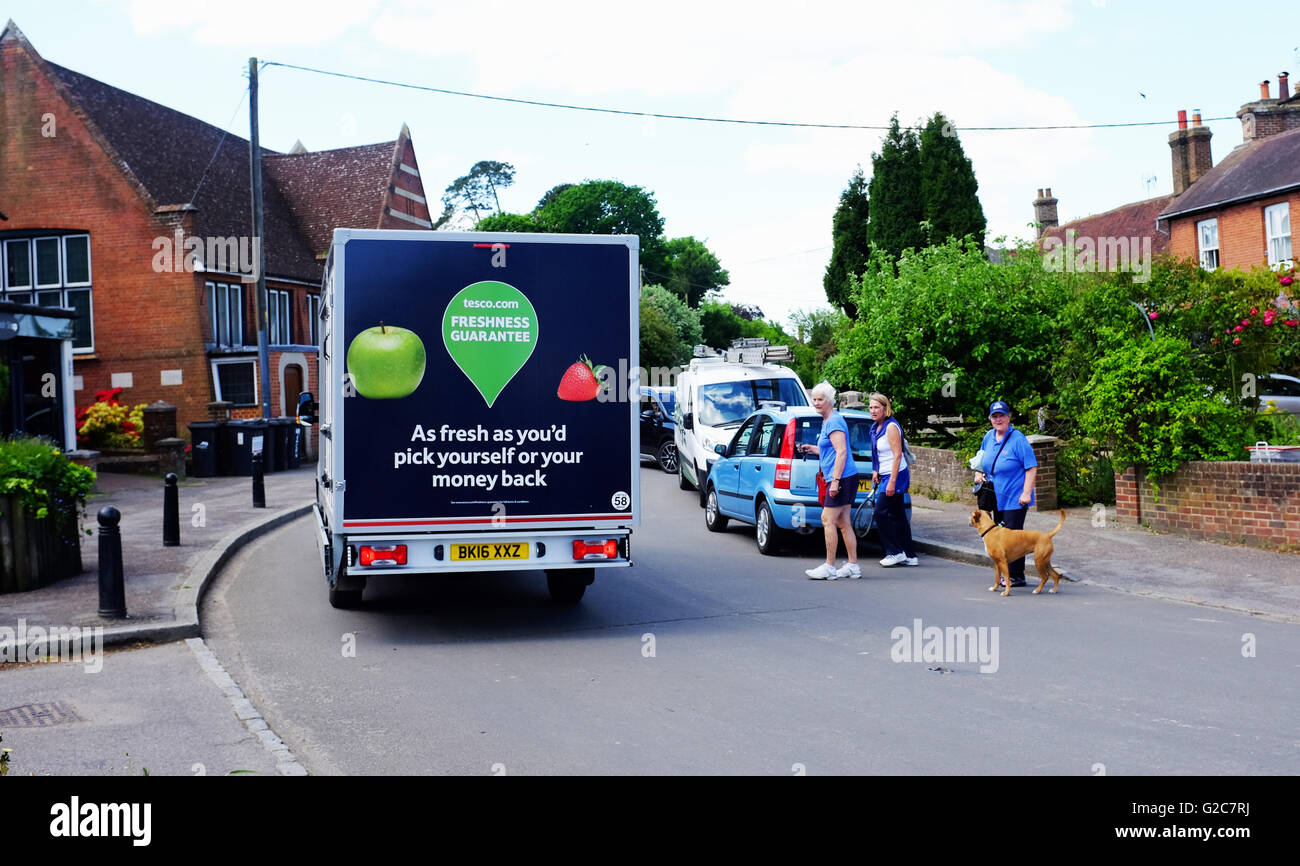 Tesco delivery van driving through village of East Hoathly East Sussex UK Stock Photo