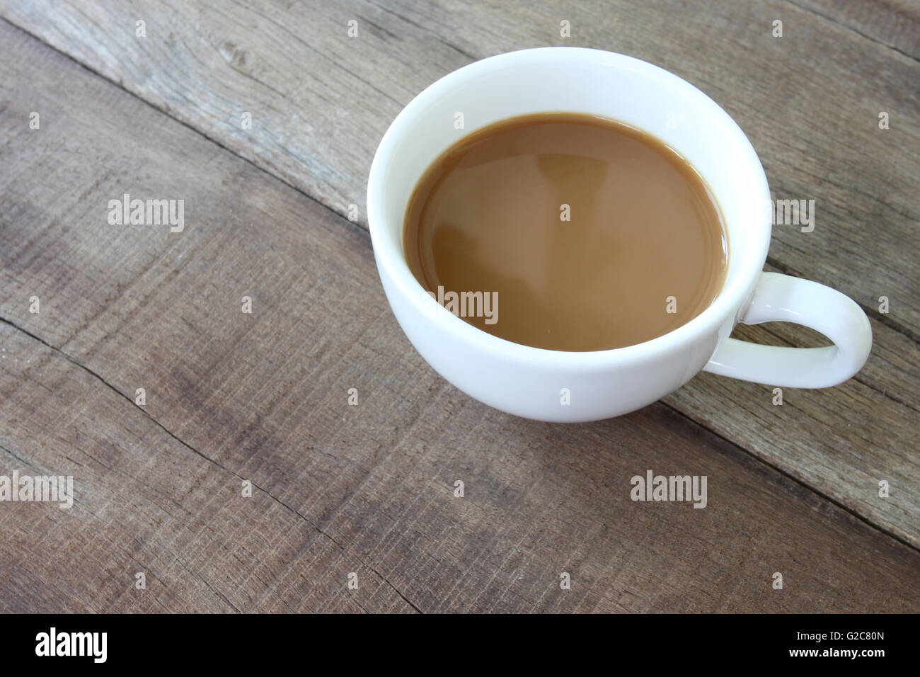 White coffee cup on a wooden floor and concept for beverage. Stock Photo