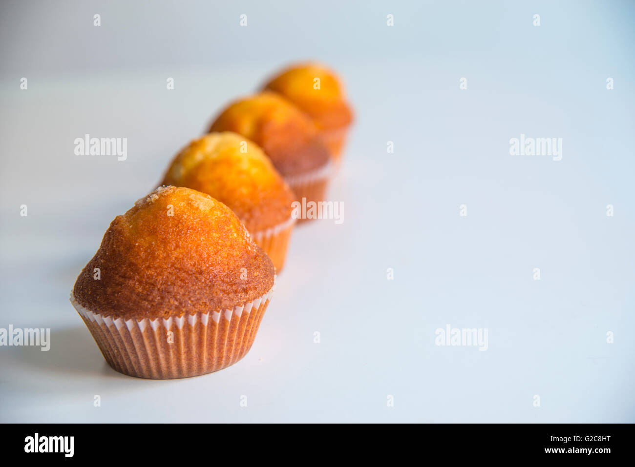 Four muffins in a row. Stock Photo