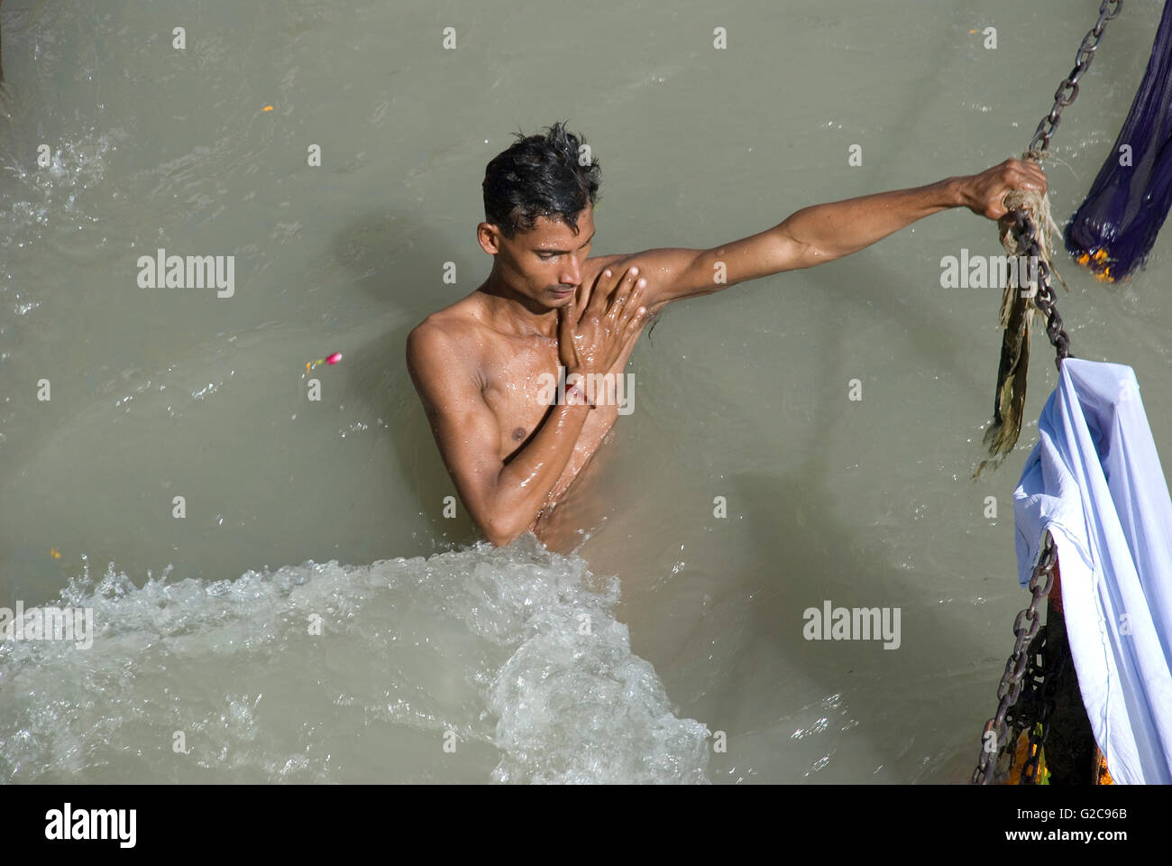 Hindu pilgrim taking a holy bath in the Ganges river, Har ki Paudi, Haridwar, Uttarakhand, India Stock Photo