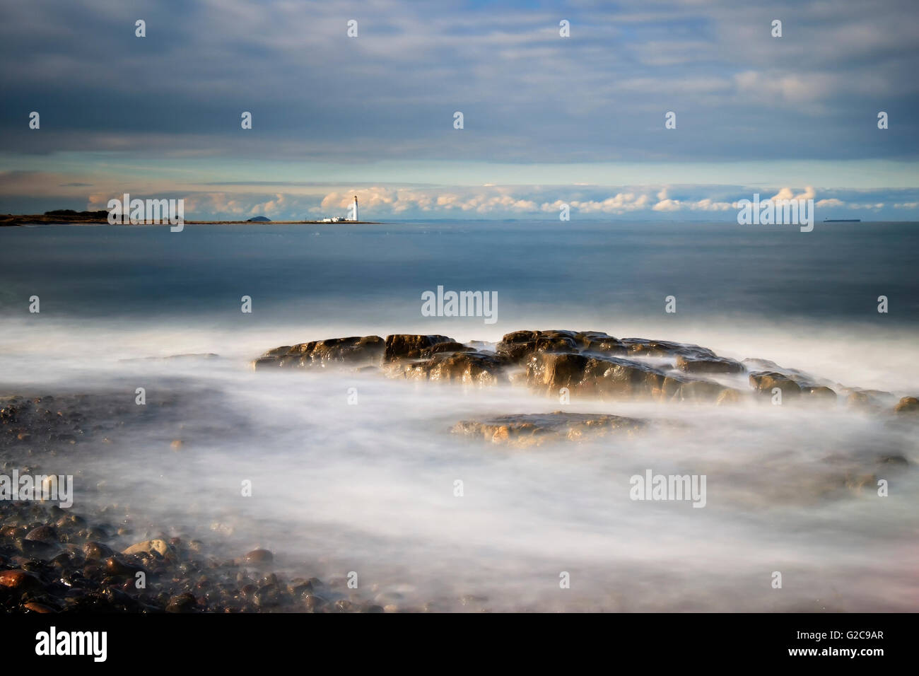 Waves breaking over rocks in the Firth of Forth, Scotland. Stock Photo