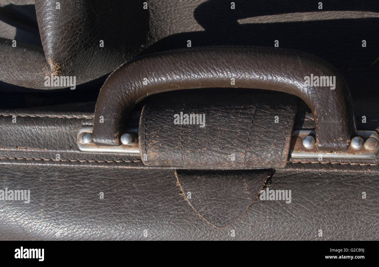 Close up of handle on old worn leather briefcase Stock Photo Alamy