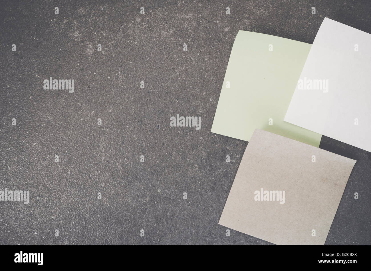 blank memos on a rough stone surface - space for your text Stock Photo