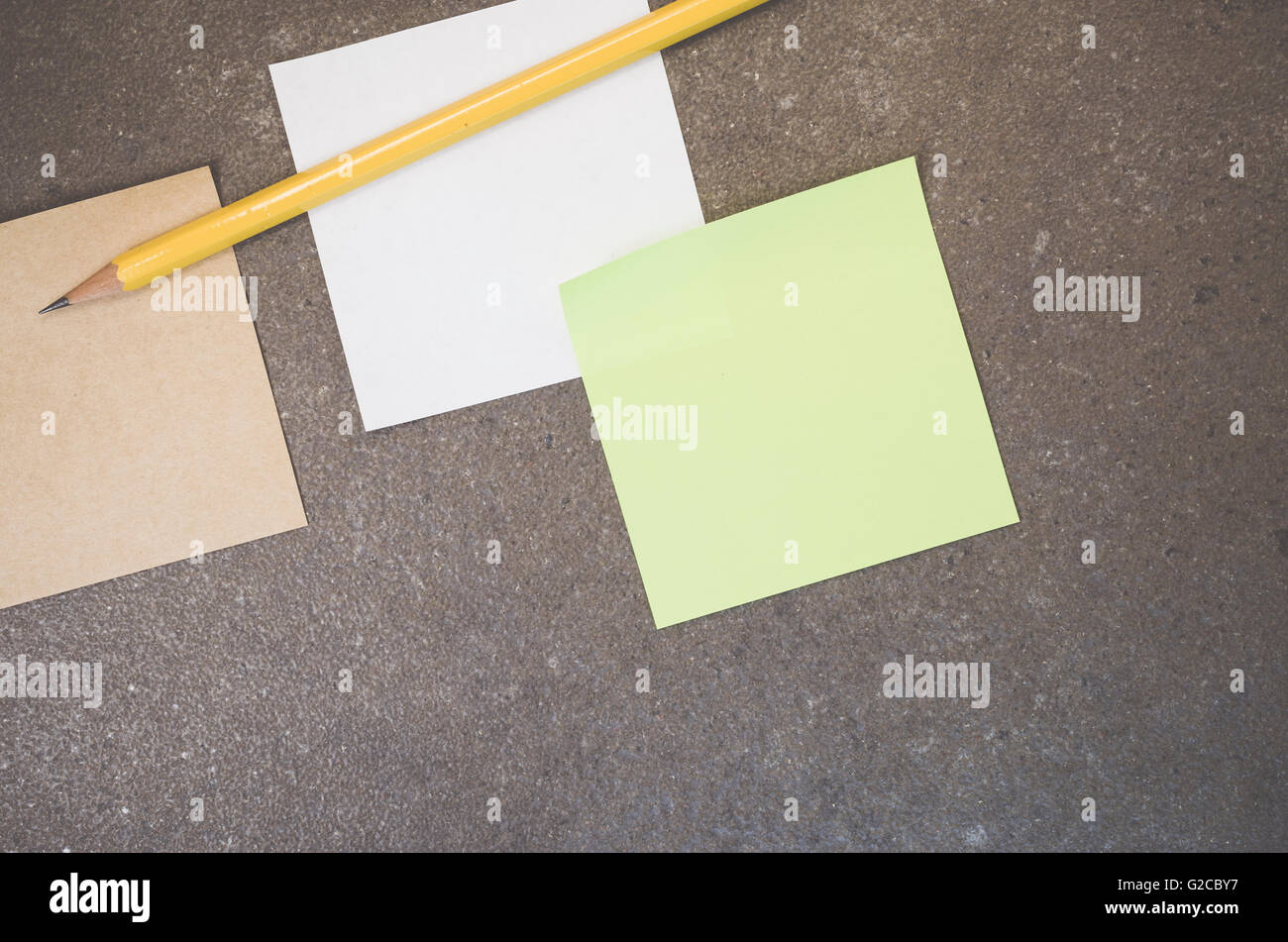 blank memos on a rough stone surface Stock Photo