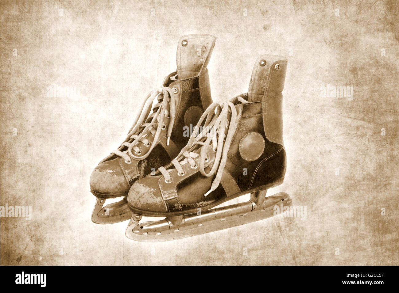 pair of old ice skates, textured background, black and white version, retro, vintage Stock Photo