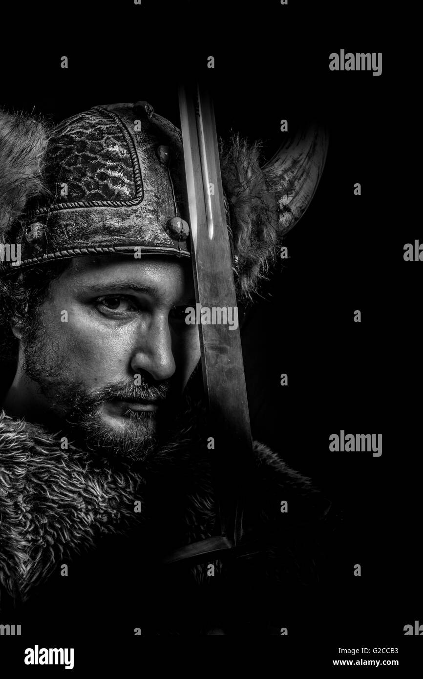 Metal, Costume, Viking warrior with a huge sword and helmet with horns Stock Photo Alamy