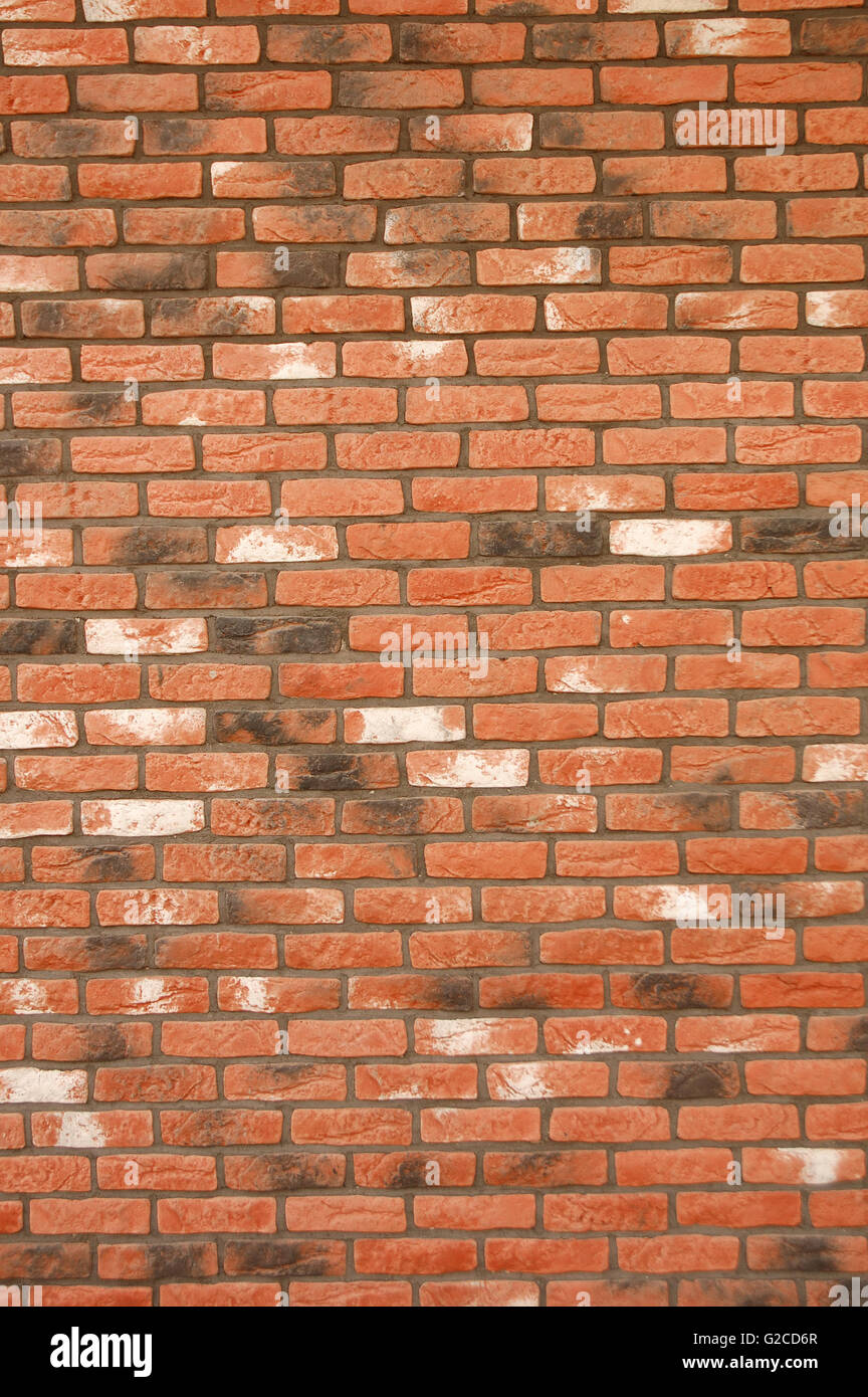 Small red brick wall of the building - background Stock Photo