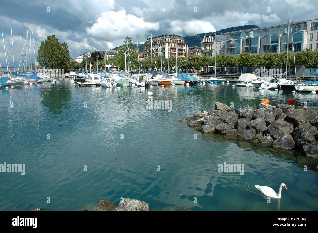 Vevey, Switzerland - August 16, 2014: Marina and buildings in Vevey at Geneve lake in Switzerland. Unidentified people visible. Stock Photo