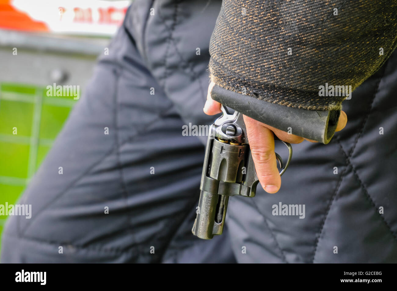 A police dog handler holds a gun used during attack dog training Stock Photo