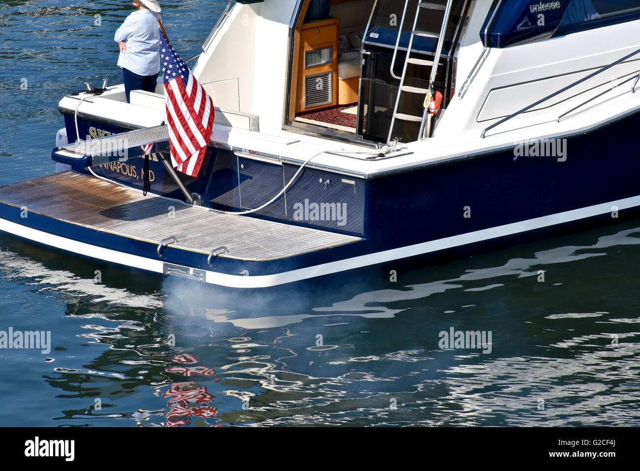 Luxury boat in the water with smoke emissions coming from the exhaust
