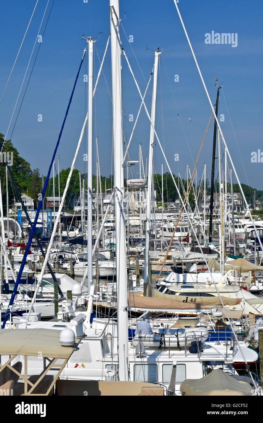 Sail boats lined on a dock with tall masts Stock Photo