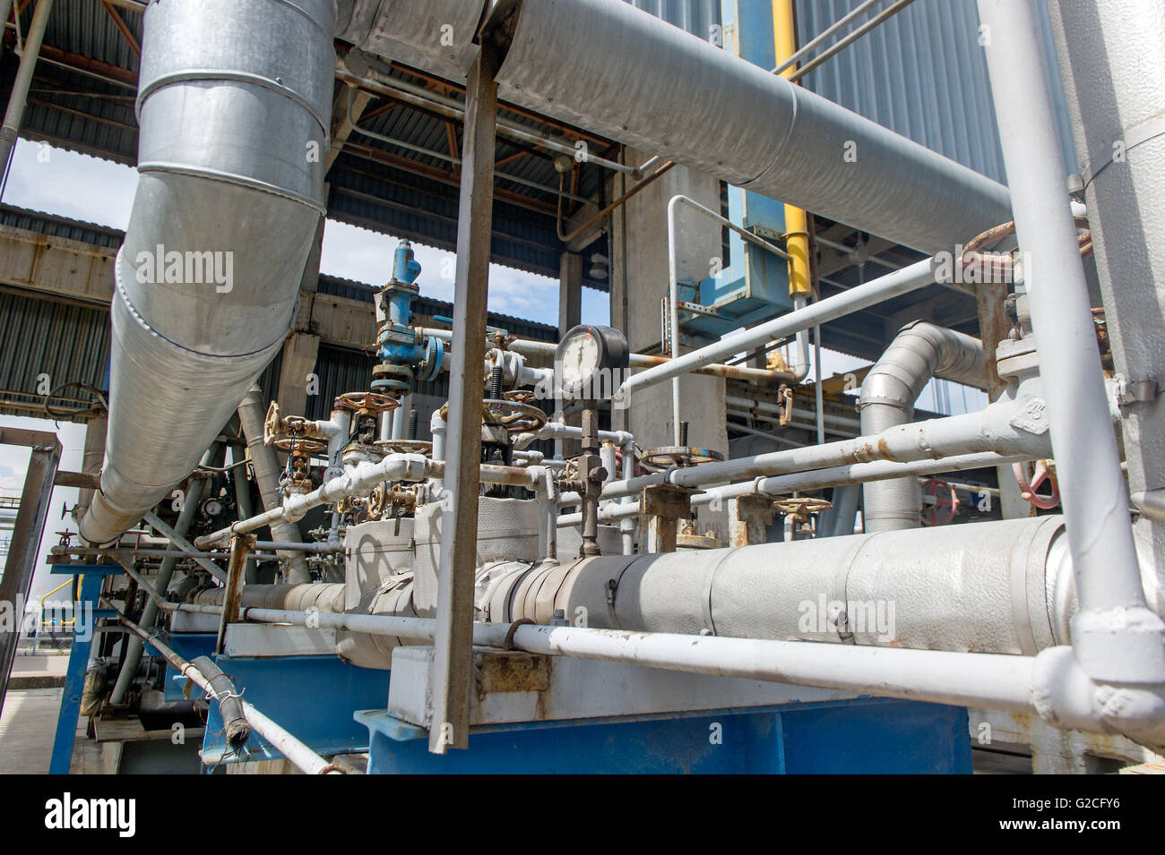 Industrial equipment and pipelines at the gas processing plant on a summer day Stock Photo