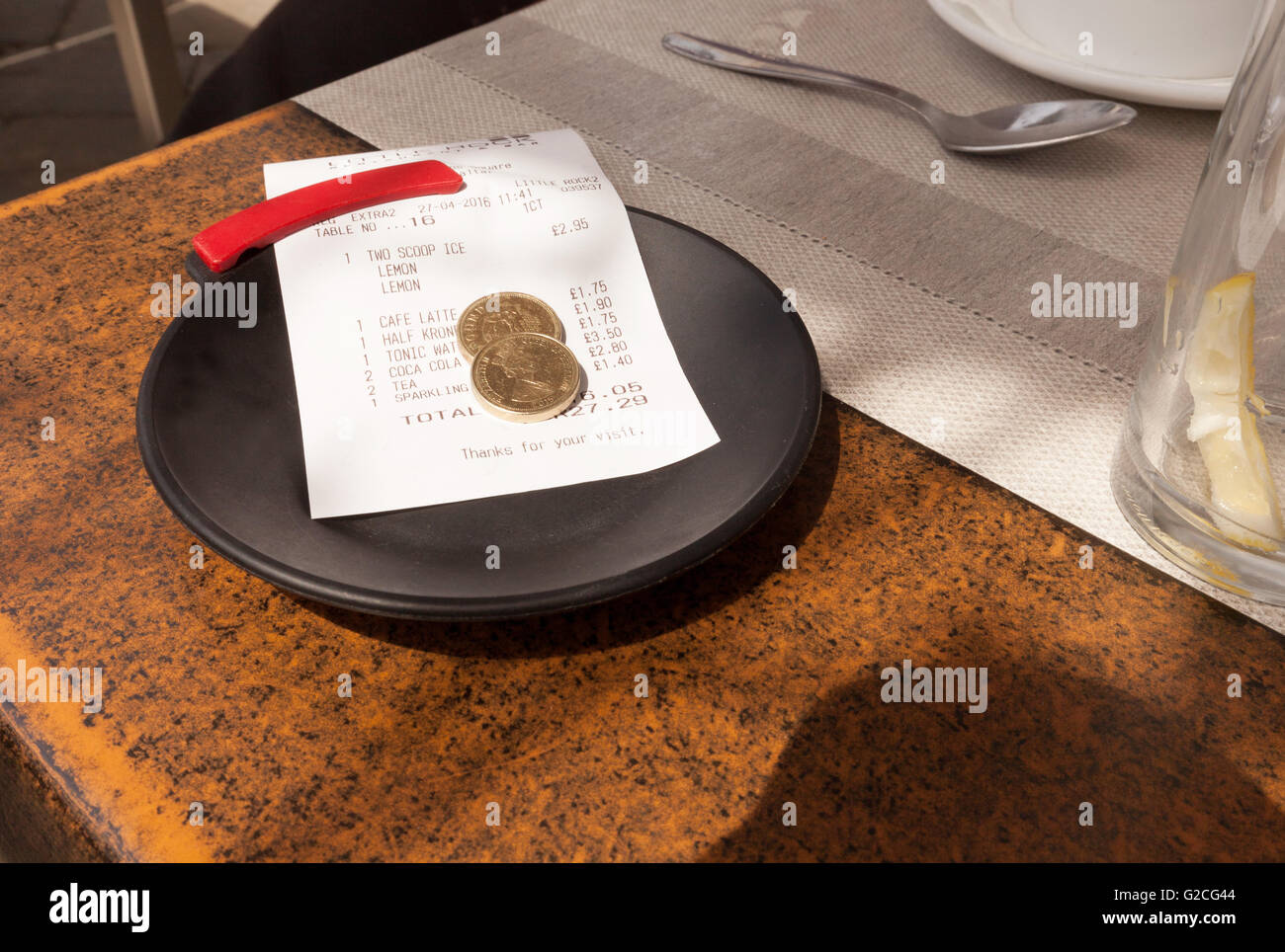 A tip left on the table with a bill Stock Photo
