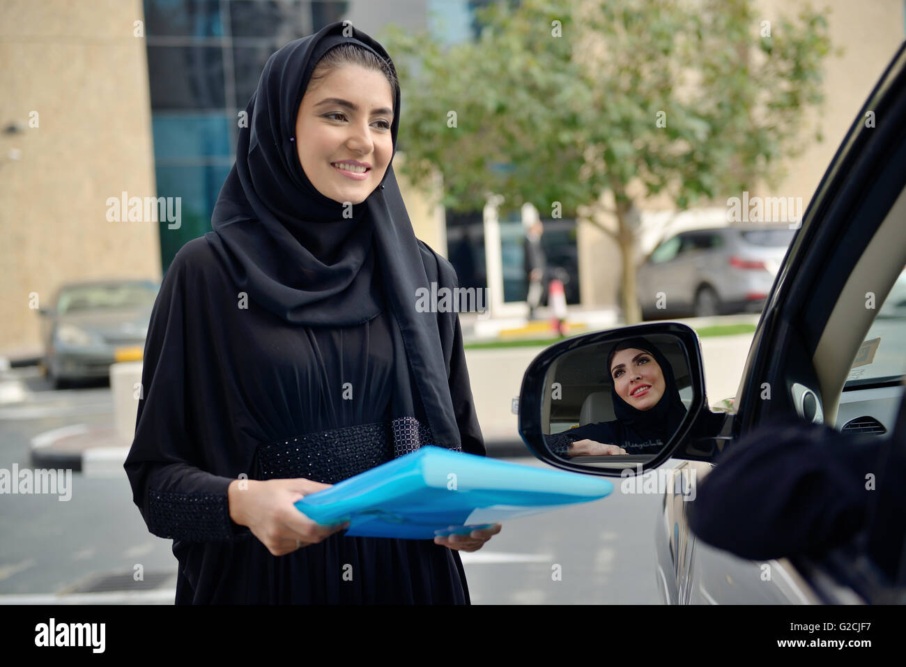 Emarati Arab Business women getting into the car in Dubai, United Arab Emirates. Stock Photo