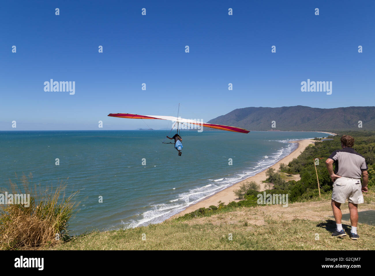 Port Douglas, Australia - April 27, 2015: Hang glider starting from from Trinity Bay lookout. Stock Photo