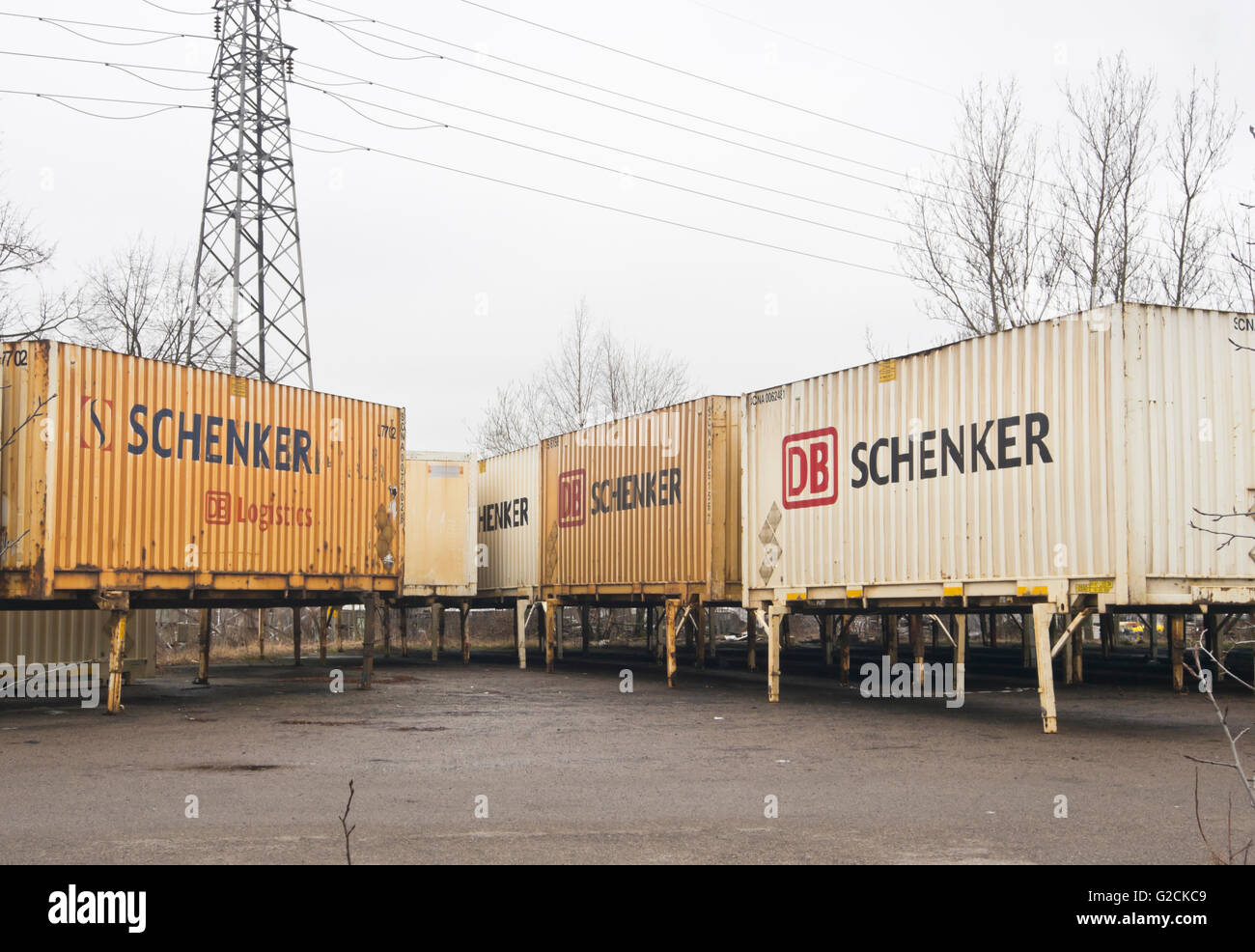 Well used yellow and white transport containers from the German company DB Schenker in a yard in Oslo Norway Stock Photo