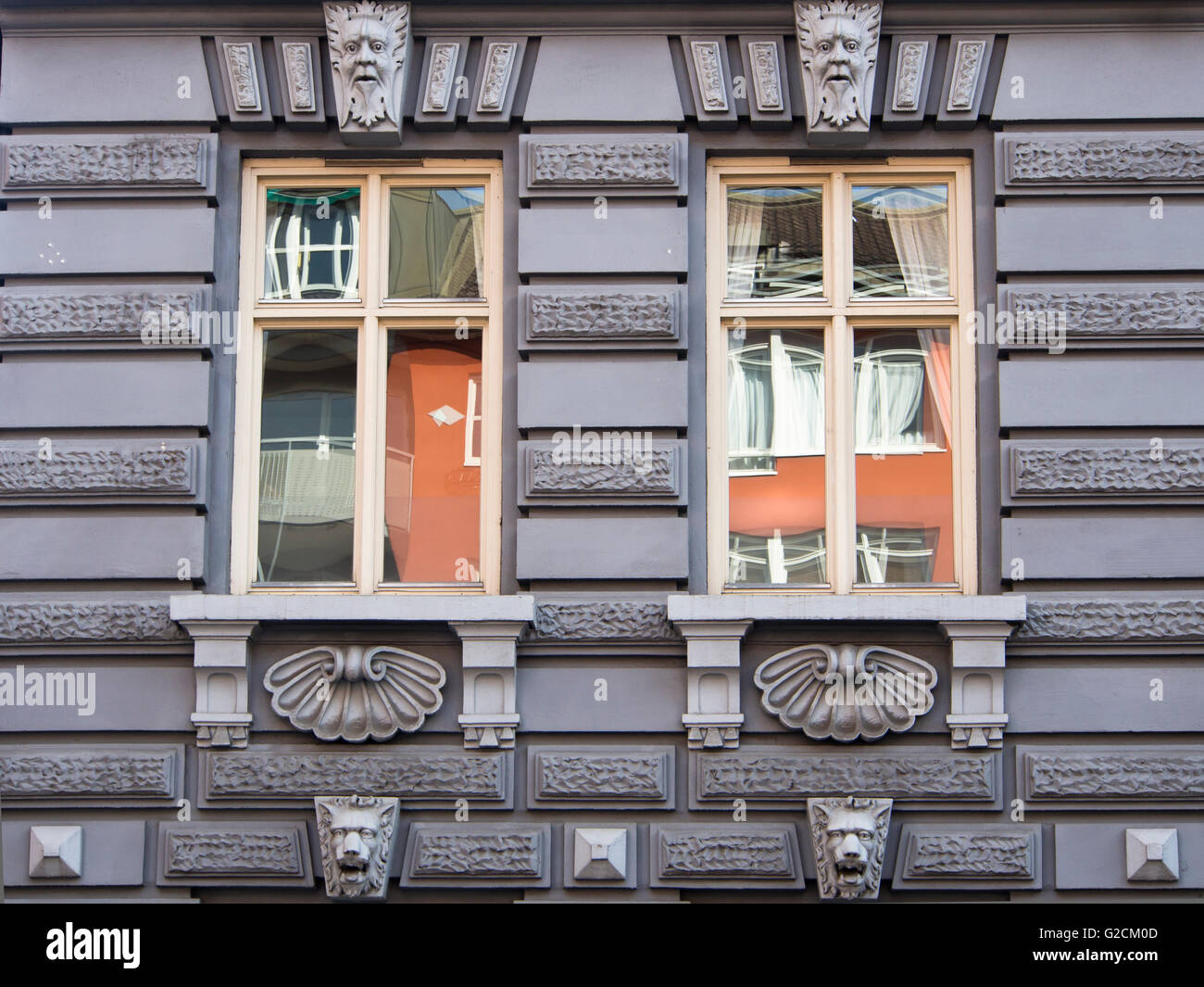 Architectural detail in inner city Oslo Norway, apartment block, windows with colourful reflections and elaborate decorations (ca 1900) Stock Photo
