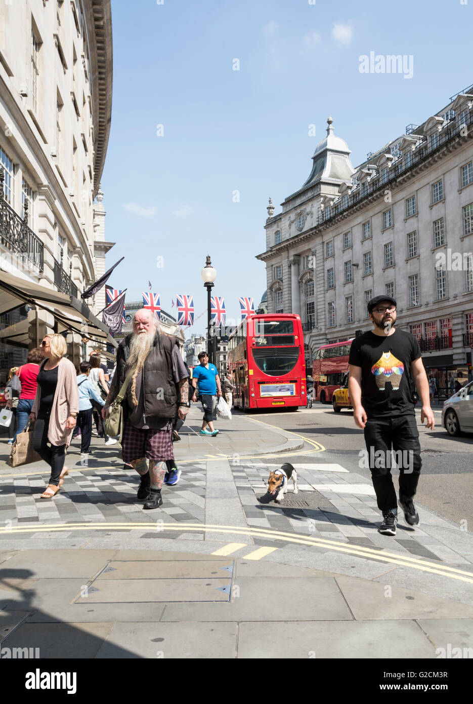 A bearded old man walks his JAck Russell dog along Regent Street, near Piccadilly Circus, in central London Stock Photo