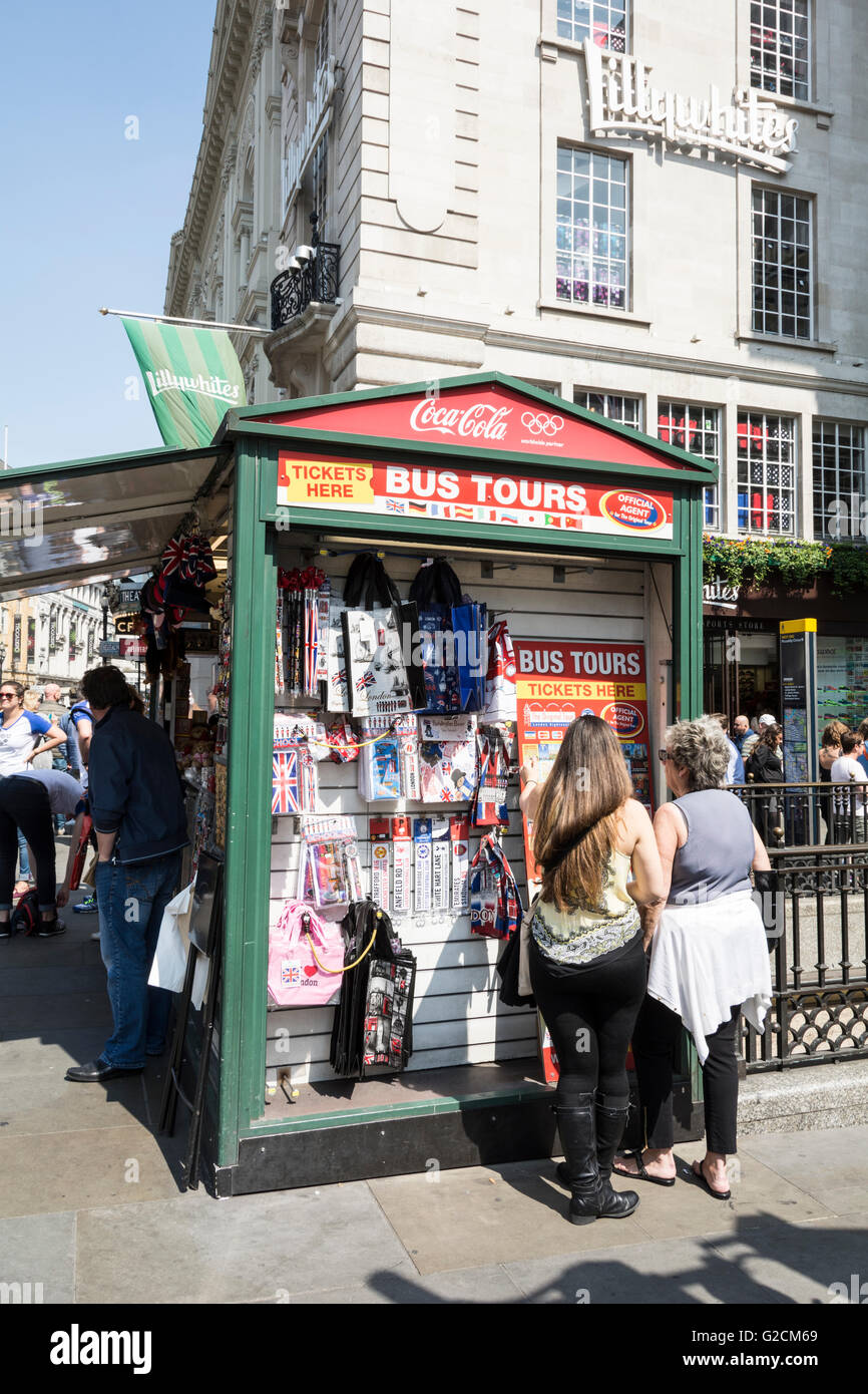 A street stall on Piccadilly Circus selling tourists trinkets, bus tours and badges etc. Stock Photo