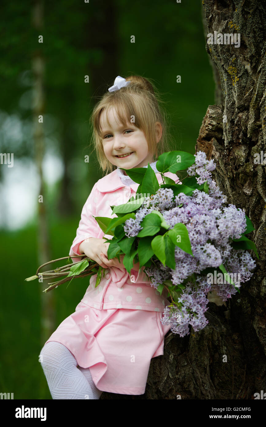 little girl with lilac bouquet Stock Photo - Alamy