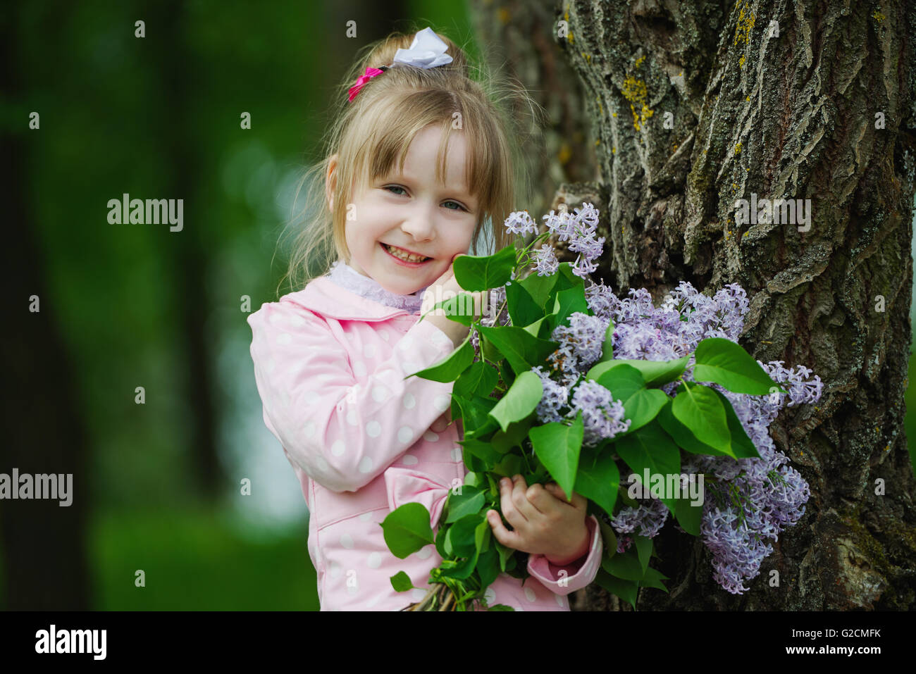 little girl with lilac bouquet Stock Photo - Alamy