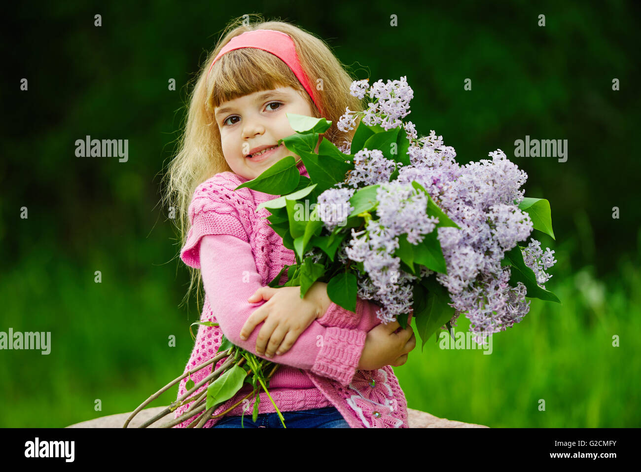 little girl with lilac bouquet Stock Photo - Alamy