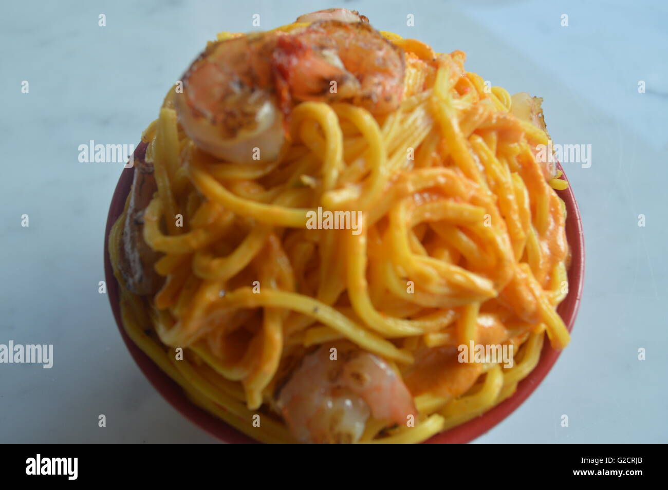 Shrimp Scampi Rice Noodles mixed in a spectacular milk sauce with sofrito. Stock Photo