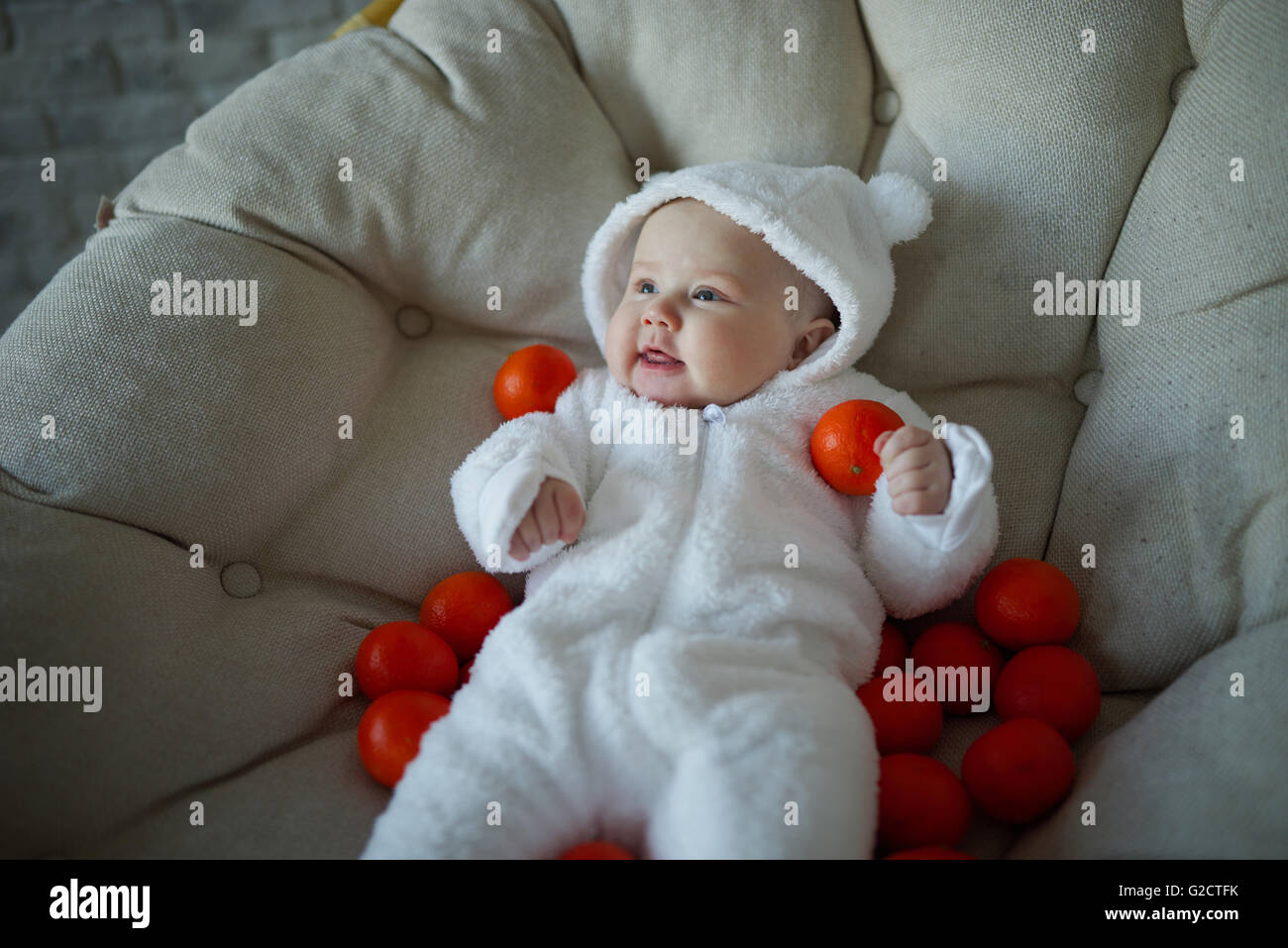 cute baby with many tangerines Stock Photo Alamy
