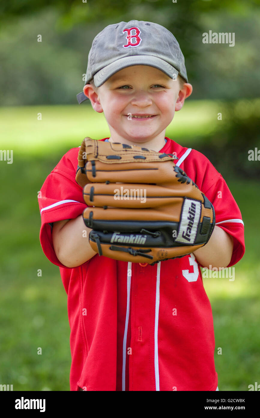 The baseball glove is bigger than the 3 year old. Stock Photo