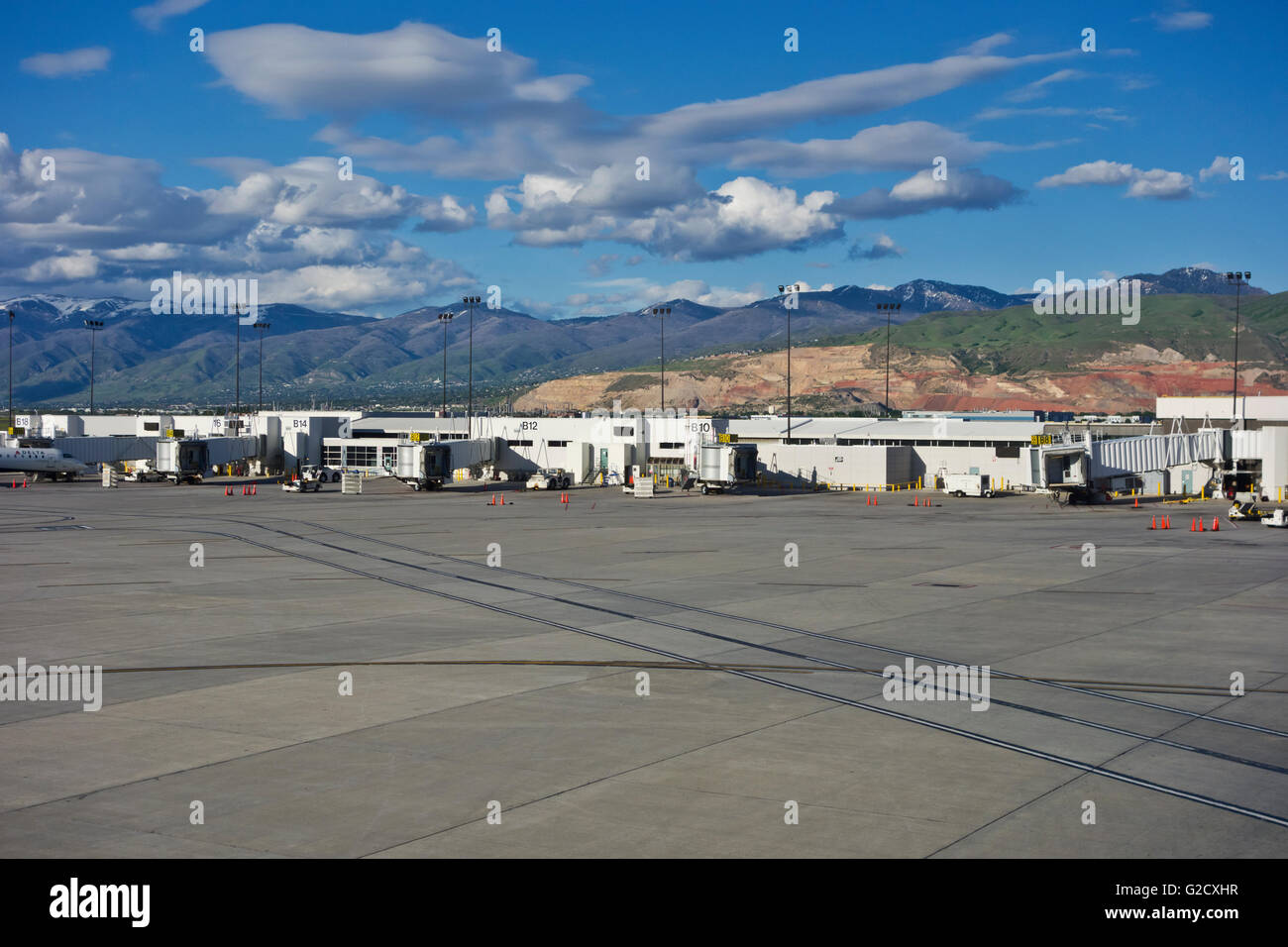 Tarmac and exterior departure and arrival gates at the Salt Lake City International Airport.  Mountains scenery. Stock Photo