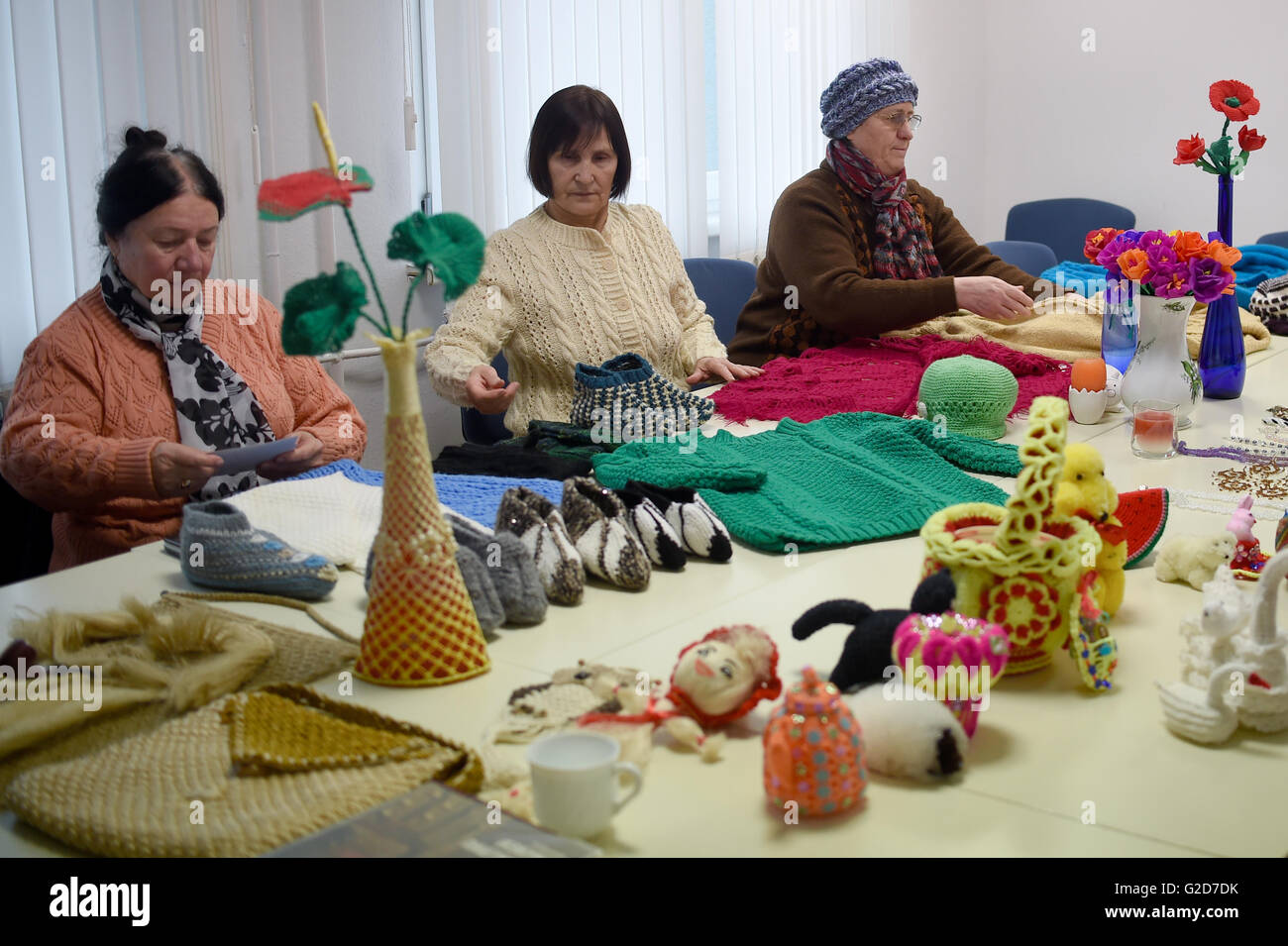 A group of handcraft makers working on lace and crochet projects at the ...