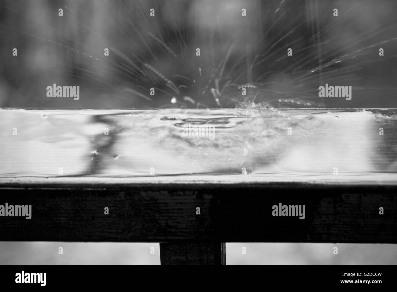 Rain Drops Splashing on Railing Stock Photo